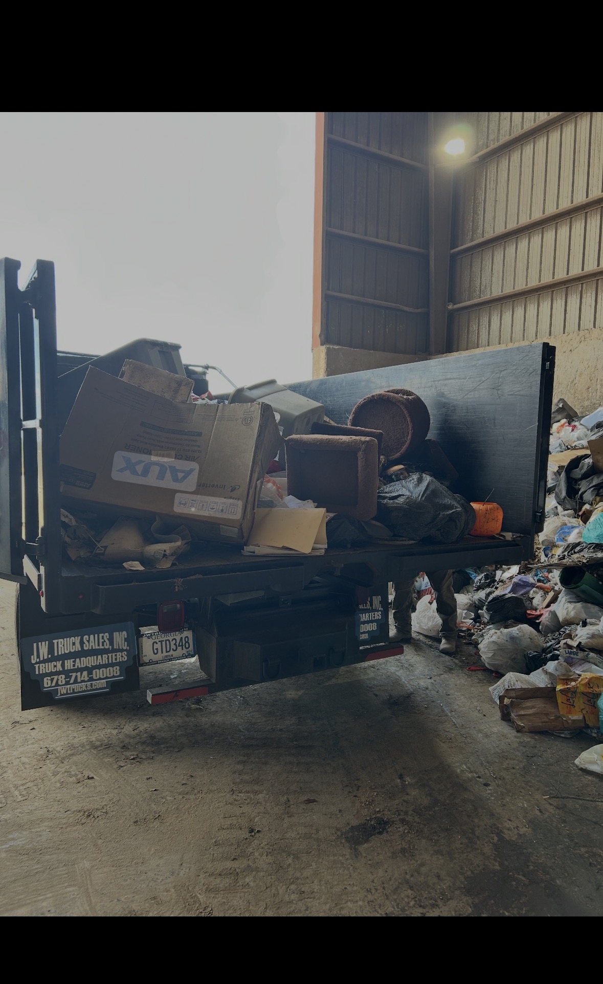 Dump truck carrying household junk