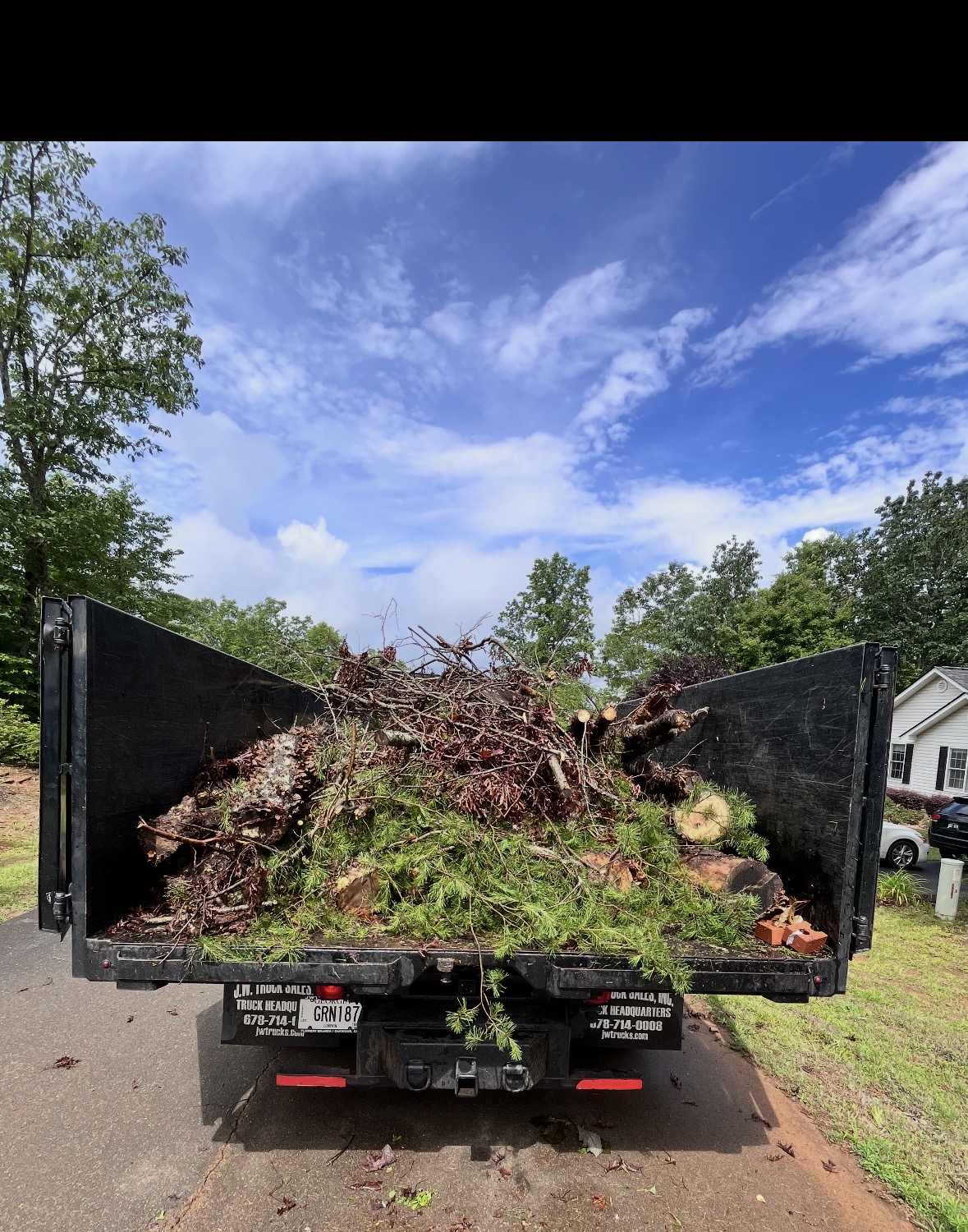 Dump truck loaded with brush and limbs